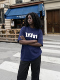 DAXUEN navy blue oversized wavy wordmark graphic T-shirt — model photo