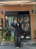 DAXUEN Wide-leg distressed denim trousers — model photo