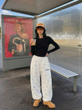 DAXUEN Wide-leg snowflake pattern casual pants — model photo