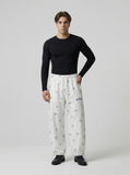 DAXUEN Wide-leg snowflake pattern casual pants — model photo