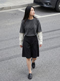 DAXUEN Men's wide-leg summer shorts in dark olive green and black — model photo