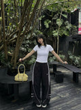 DAXUEN Wide-leg track pants in solid colors — model photo