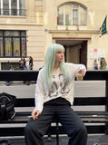 DAXUEN black textured knit top with winged and cloaked graphics — model photo