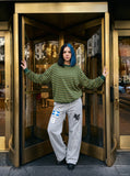 DAXUEN grey wide-leg sweatpants with winged horse and cross graphics — model photo