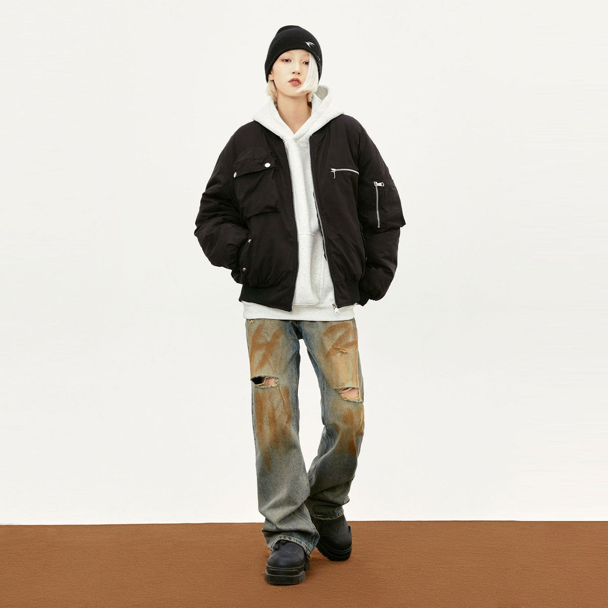 Model wearing the black Retro Classic Multi-Pocket Bomber Jacket in a gray background 