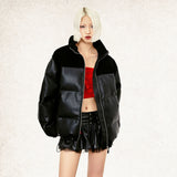 Model wearing the black Loose Padded PU Leather Jacket in a gray background 
