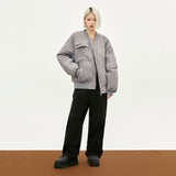 Model wearing the grey Retro Classic Multi-Pocket Bomber Jacket in a gray background 