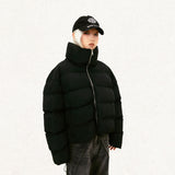 Model wearing the black Solid Color Pleated Padded  jacket  in a gray background 
