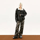 Model wearing the black Vintage Washed PU Leather Jacket in a gray background