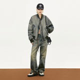 Model wearing the green Dyed Distressed Padded Jacket in a gray background 