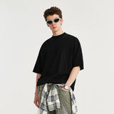 A model wearing the black High-neck Respecting Solid Loose T-shirt from DAXUEN.