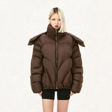 Model wearing the brown Multi-module Padded Jacket in a gray background 