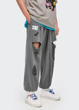 A guy wearing Charcoal DAXUEN Hole Ripped Sweatpants
