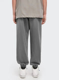 A guy wearing Charcoal DAXUEN Hole Ripped Sweatpants